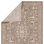 Back corner of the rug folded to reveal the lighter reverse side and edge binding