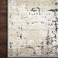 Close-up of Lucia Granite Rug corner on dark wood floor showcasing detailed color blending and texture