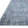 Angled view of rug surface emphasizing textured weave and tonal variations in grey and blue