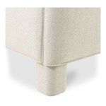 Close-up of rounded upholstered leg and seam of Ichigo bed in beige fabric