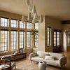 Heritage Bark Multi Rug in bright living area with large windows, beige sofa, and round white ottoman