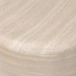 Close-up of table’s curved side surface showing fine travertine vein patterns