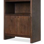Close-up of lower cabinet doors highlighting wood grain and small black round handles