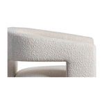 Close-up showing top of curved armrest and plush seat fabric on Elo Chair