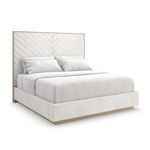 Modern bed with tall chevron-patterned padded headboard and low-profile upholstered base in a light beige fabric