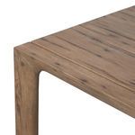 Close-up on another corner of oak table highlighting natural wood knots and chamfered edges