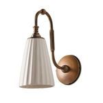 Wilma Sconce angled side shot showing full ceramic shade, brass arm, and wall mount