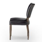 Side view of chair showing thick cushion profile and gently curved back with gold nailhead trim