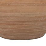 Close-up detail of the lower part of the terracotta base highlighting horizontal lines and natural imperfections