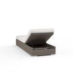 Chaise backrest raised with underside open to reveal storage compartment inside wicker base