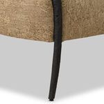 Close-up on slender hammered metal leg highlighting base support and frame finish