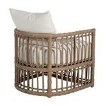 Back view of chair with off-white cushions emphasizing rounded rattan frame