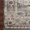 Detailed close-up of Hathaway rug corner showing faded floral and geometric pattern on wood floor