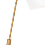 Mid-section of lamp showing angled brass-toned metal arm connecting base to white shade