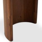 Angle focusing on underside of marble top and detailed seam with acacia crescent leg