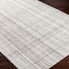 Sammy rug with angled close-up showing flat weave texture on dark wood flooring