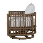 Side angle highlighting back cushion shape and wicker barrel chair design
