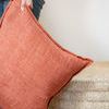 Person holding Burbank Aragon Pillow showing its size and soft texture