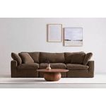 Terra Modular Sofa in a dark brown fabric styled in a minimalist room with round wood coffee table