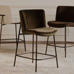 Dark olive and chocolate color variations of Early stool paired with the beige version in room