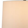 Close-up of beige fabric lampshade showing fine weave texture and faint shadow of lamp frame