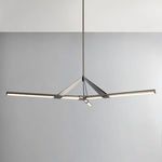 Side view of chandelier hanging in room with gray wall background showing structure with lights on