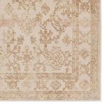 Close-up of central medallion and floral motifs with subtle faded pink and blue accents on ivory background