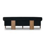 Repeat of room context with sofa styling against wood panel wall and decorative items
