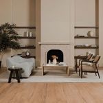 Living room with Bria sofa paired with wood coffee table, fireplace, and two upholstered chairs
