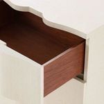Open drawer showing warm natural wood interior contrasting the light textured exterior of the Bardot side table