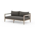 Angled view of Sherwood sofa displaying woven cotton back panel and light teak frame