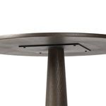 Lower section of dark oak base showing circular solid wood footrest ring detail