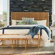 Escape Nesting Headboard styled in coastal bedroom with pillows, a bench, and ocean view