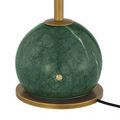 Close-up of green marble base with subtle variations and round brass on/off button