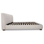 Side view showing empty slatted bed base and low rounded frame of storage bed