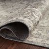 Folded edge of Hathaway rug highlighting its thin, flexible polyester material