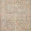 Traditional style rug with vintage-inspired apricot and natural tones featuring intricate faded floral and geometric motifs