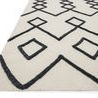 Close-up angled view showing high/low textured wool pattern and flat woven cotton background