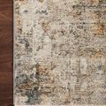 Corner of Axel Ocean Rug on wood floor highlighting pile texture and combination of beige, rust, and gray colors.
