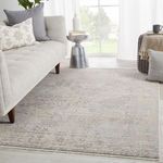 Lourdes Trellis rug placed on light floor with sofa and side table near window in a modern living room