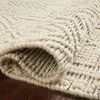 Rolled edge of Noelle Ivory / Black Rug revealing its thickness and looped textured weave