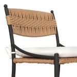 Close-up angled front view revealing cushion thickness and woven seat texture