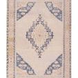 Distressed tan and blue area rug with vintage medallion, geometric border, and floral detailing