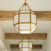 Multiple Morris Small Lantern pendants aligned in hallway with wood ceiling beams and white walls