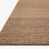 Close-up angled view showing detailed woven texture and thickness of Lily Natural Rug edge