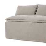 Lower front corner close-up focusing on slipcover's flanged top seams and fabric texture