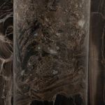 Macro detail of dark marble base with complex swirling stone veining and texture