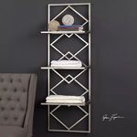 Uttermost Silvia Silver Wall Shelf mounted on dark wall with decorative balls, books, and folded towels on shelves, next t...