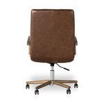 Zoom on button tuft and seam details on deep brown leather chair backrest.