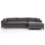 Front view of sectional showing raised seating cushions and straight back cushions without pillows